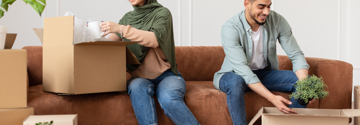 Couple unpacking their boxes in new home