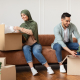 Couple unpacking their boxes in new home